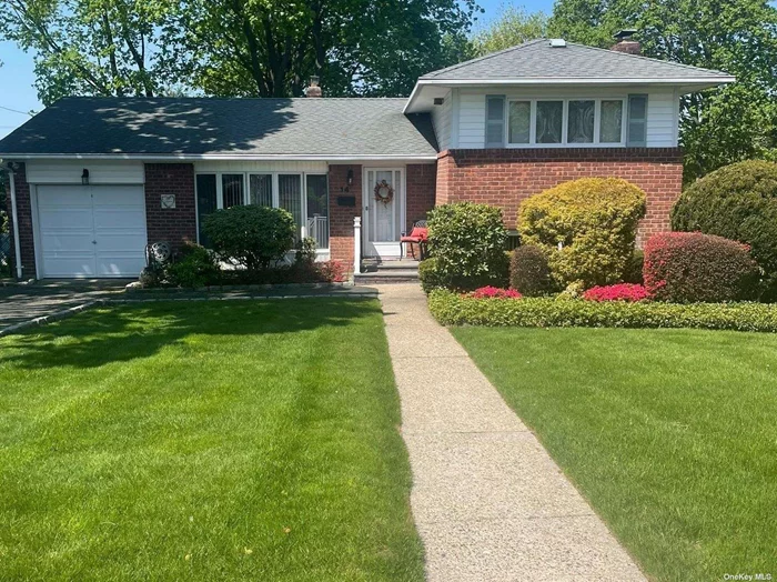 Beautifully Maintained Split Level in the Commack Birchwood Section. Fabulous Curb Appeal. Great Layout Features Include Large Living Room, Eat-In-Kitchen, Formal Dining Room with Sliders to Lovely Landscaped Yard and In-Ground Pool (new liner 2023), Upstairs to Primary Bedroom, Full Bath, and Second Bedroom,  Downstairs Has Large Den with Cozy Brick Wood Burning Fireplace With Private Outside Entrance, Bathroom (.5), and Bedroom. Ample Sized Basement (Clean with Tons of Storage),  1 Car Garage, Anderson Windows Throughout, Wood Floors Entire Upstairs, Livingroom and Hall, Central Air Condition, New Heating System (2022),  Security, In-Ground Sprinklers, Pretty Tree Lined Block (mid block location), Sidewalks all within Smithtown Township and Commack Schools. Great Opportunity!