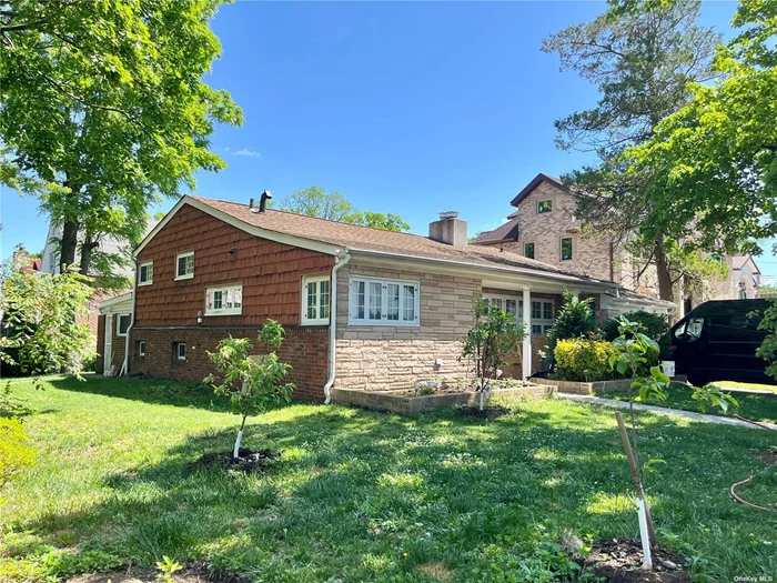 Beautiful Sprawling split ranch in North Flushing. 2094 sq. ft. of living space on a oversized corner lot and minute to Bowne Park, Eat-in kitchen, formal dining room, 5 bedrooms. large entry porch into foyer and living room with fireplace. Finished basement with laundry room. School District 25, P.S 184, IS 025, Francis Lewis H.S, Nearby shops, public transportation,