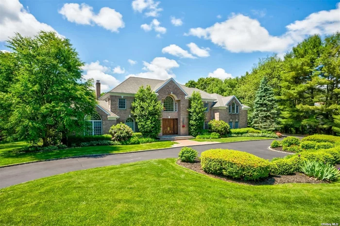 Introducing a majestic, move-in ready, Center Hall brick colonial nestled in the esteemed enclave of Muttontown. This stately home is ideally situated near top-rated golf courses, a luxurious yacht club, and extensive walking and horse-back riding trails within a 500-acre preserve. The Syosset LIRR train station is just a short drive away, ensuring a seamless 45-minute commute to New York City. The grand two-story entry foyer ushers you into a state-of-the-art gourmet kitchen featuring pristine cherry cabinetry, granite countertops, high-end appliances, floor with radiant heat and a convenient butler&rsquo;s pantry. The adjacent den is highlighted by a wood-burning fireplace and French doors that open to a terrace overlooking the breathtaking two-acre park-like property. Natural light floods the formal living room, which connects to the den via another set of French doors and can be accessed from the entry foyer. The formal dining room boasts chair rail molding, palladian windows, and beautiful hardwood floors, creating an ideal environment for sophisticated gatherings. The main floor includes a secluded home office, perfect for privacy and focus. Upstairs, the primary suite with tray ceiling features walk-in closets and a luxurious marble bath with a Jacuzzi tub and floor radiant heating and private water closet. One guest bedroom with full bathrooms and walk-in closets, two large bedrooms with sharing bath. A separate guest suite is accessible through a secondary staircase. This pristine home also offers a vast basement with 9 ft. ceilings, a built-in dehumidifying system, and a whole-house water filtration system. Additional features include a three-car garage and professionally landscaped grounds, all within the coveted Syosset school district.