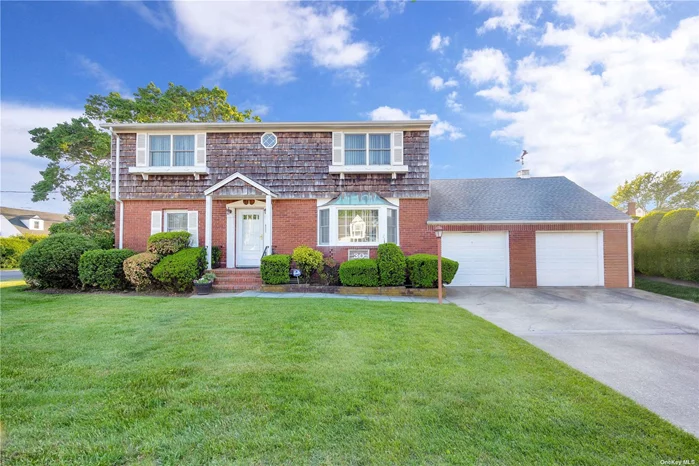 Beautiful large center hall Colonial situated on quiet block in prime Woodward Pkwy area, great curb appeal with brick & cedar sided exterior, flowerboxes, window shutters, copper flashing, double cement driveway, bluestone walkway, brick stoop & steps, manicured landscaping, brick planters. LR & FDR w/ wall to wall carpeting & hi hats, large brand new EIK w/ custom cabinets, granite countertops, ceramic tile backsplash, new flooring, stainless steel appliances, subzero refrigerator, & sliding doors to backyard. Second floor front & rear dormered, large MBR w/ hardwood floors, WIC & MBR Fbth w/ walk-in shower, 2 other large BRS w/ hardwood floors & double closets, & additional ceramic tile Fbth. Basement newly finished w/ entertainment center, LR, BR w/ crown moldings, new Fbth, plenty of storage. Andersen windows, verticals, CAC on 1st & 2nd floor. Gas heating system & separate hot water storage tank installed in 2013, 3-zone heat, 150-amp electric w/ subpanel, roof approx. 8 years old, alarm system, 2 car attached garage. Oversized privately fenced backyard, 6ft cedar fencing, patio, IGS, security system. Convenient to all transportation & shopping, Woodward Pkwy Elem School.