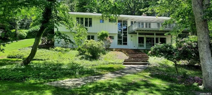Private waterfront setting directly on the Nissequogue River with Boat House, minutes from the center of town. Canoe/kayak launch, quiet, serene, wooded bird lover&rsquo;s paradise, just shy of one acre. Split-level ranch with panoramic views from the house, and from the large new 2nd floor deck, perfect for entertaining. Expansive slate patio fronting the river on lower level runs the length of the house. Three bedrooms, kitchen, living and dining rooms are on upper entry level with 2-story wall of glass windows overlooking river. Huge Primary Bedroom has en-suite bath and 2 closets. Two additional bedrooms and another full bath on upper entry level. Large EIK w/tile center island, Oak Cabinets, built ins. Additional airy sun room with skylight off kitchen could be converted to maid&rsquo;s quarters. Across from that room is spacious laundry room. New wood floors. IGS and security system. Generac provides immediate power backup. Lower level encompasses 35 ft long additional living room w/large windows overlooking the river, built in stereo and record player w/in-wall speakers, power outdoor vertical shutters and brick fireplace recently converted to gas. There is also another full bath and a large office on lower level which can convert to 4th bedroom, plus a playroom/craft room with built-in storage. Additional storage in basement area on same level. Extensive brick and slate work on entire property. The LIRR and supermarket are 2 minutes away by car. This is the first time this property has been on the market since it was built in 1961, and has been lovingly maintained by one owner. All of the land in sight across the river is a nature preserve and will never be built on so the view is of unobstructed panoramic woodland and wetlands. Your opportunity for riverfront living minutes from Main Street in Smithtown.