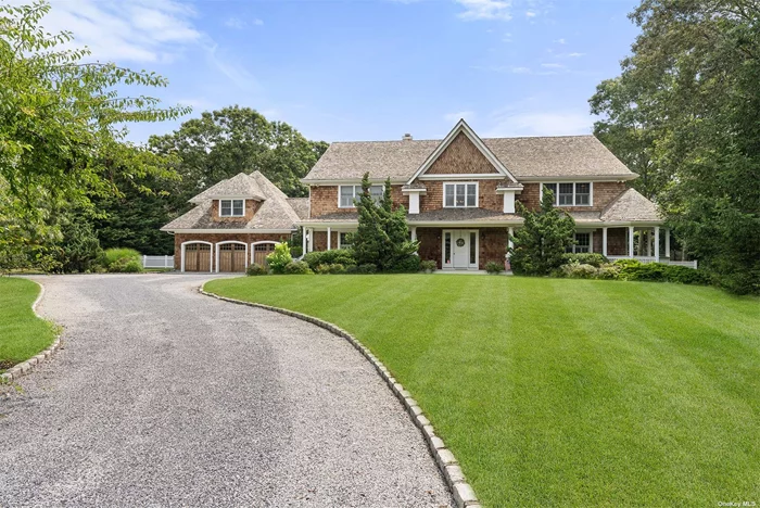 Located in the heart of Quogue South, this stunning estate sits on 1.7 acres, off a private road. With over 7, 600 sf of elegantly appointed living space, the 30&rsquo; tall entry provides a hint of the meticulous custom millwork throughout. The first floor features a living room with a fireplace and French doors which open to a spacious yard with a heated gunite pool surrounded by a classic brick patio. The main kitchen showcases an oversized granite center island, high-end appliances, and a dining-sized breakfast area in addition to a large, fully equipped catering kitchen. The grand scale of the first floor is complete with a second primary en suite, a family room with a private covered lounge area, a half-bath that opens to the pool, a formal dining room with a fireplace, and a powder room. The massive second-floor primary suite has a private balcony, double walk-in closets, and a fireplace. The en suite bath is framed with marble and features two vanity areas, a double steam shower, and a Jacuzzi. Three additional guest rooms, including one en suite and two with a bath, plus a terrace and a laundry room complement the upstairs. Additional amenities include an entertainment room with a 16&rsquo; vaulted ceiling and a three-car garage. Ideally located close to the village market, shops and ocean beaches