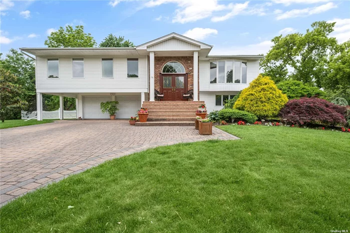 Welcome to 18 Peppermint Rd in the heart of Commack, where true pride of ownership greets you at the front door. Nestled in the sought-after Candy section, this expanded Hi-Ranch boasts four spacious bedrooms and three full bathrooms, all set on a shy half-acre property. From the moment you arrive, the meticulously maintained paver driveway and double-door entry set the tone for the elegance within. Step inside to gleaming hardwood floors and soaring vaulted ceilings, complemented by skylights that fill the space with natural light. The living room features a mirrored wall, adding a touch of sophistication, while the dining area dazzles with a luxurious chandelier. The light, bright kitchen is a chef&rsquo;s delight, with granite countertops, stainless steel appliances, and expansive white cabinetry. This modern kitchen flows seamlessly into the living room, dining room, and a generously sized great room. Sliding glass doors off the great room lead to a spacious Trex deck, perfect for outdoor entertaining and relaxing. The lower level of this home is equally impressive, offering expanded space ideal for a den, playroom, home gym, or even a potential mother-daughter setup with proper permits. The bedrooms, some with floor-to-ceiling windows, provide a serene retreat with plenty of natural light and air. The modern rustic design is both stylish and welcoming, making every room feel like a special part of the home. Additional highlights of this exquisite property include updated electrical systems, windows, roof, siding, bathrooms, heating, and central air conditioning, ensuring comfort and efficiency year-round. 18 Peppermint Rd offers the perfect blend of elegance and functionality. The surrounding neighborhood enhances the home&rsquo;s appeal, with its established community feel and easy access to all that Commack has to offer. This stunning home is ready to welcome its new owners. Don&rsquo;t miss the opportunity to make this exceptional property your own.