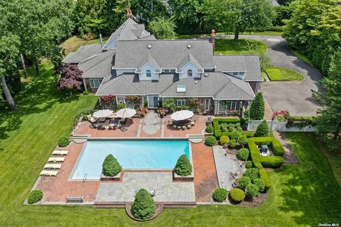 Built to Perfection with 314 Feet Frontage of Stunning Golf Course Views - This majestic brick Georgian Colonial on 2+ beautifully landscaped acres is a masterpiece of opulent design and luxury living. This sophisticated home is located in the most desired private location on the hill with breath-taking sunsets and rolling golf course views. Offering 10, 000+ square feet of luxurious living space, this manor includes seven bedrooms, six full baths, and three powder rooms. Every detail was thoughtfully selected and quality crafted, from the tile, carpeting, and inlaid wood floors to the exquisite ceiling trim work and three ornate fireplaces. Upon entry you will find a dramatic two-story grand entrance with circular staircase, a spacious family room appointed with rich woodwork and detail evident with the built-ins, custom coffered ceiling and fireplace enhancing it&rsquo;s warm and inviting ambiance. Adjoining is a banquet-size formal dining room, and an elegant formal living room with fireplace that has fairway views as long as the eye can see. The gourmet kitchen has a large center island that opens to a welcoming breakfast room. The north wing hosts the lavish primary en-suite with fireplace, two separate full baths and three spacious walk-in closets. An additional large en-suite bedroom, gym, laundry/mud room with full-sized refrigerator and freezer, and two-car garage complete the north wing. The south wing hosts two powder rooms, a serene family room, back staircase to the second floor, and an additional two-car garage. The second floor brings you to two en-suite bedrooms, three additional bedrooms, a hall full bath, and vast storage space. The basement level includes a second laundry room, storage space, and limitless possibilities. Outside features a 60x20 heated in-ground pool, expansive blue-stone patio and breathtaking fairway views making this ideal for relaxing and entertaining. Just twenty miles east of Manhattan, this magnificent home is mere minutes from golf courses, schools, stores, restaurants, and parks. Award-winning Garden City School District.
