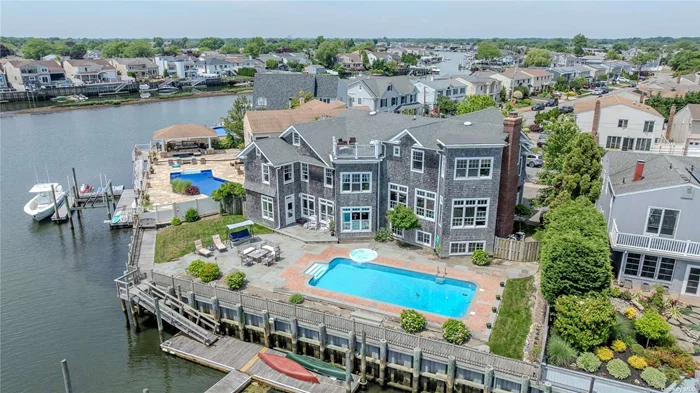 This beautiful Hamptons-style home nestled in the Mandalay area of Wantagh is unlike any other. Picture breathtaking bay views thru custom Marvin windows showcasing the serene waterfront setting. Enter into the grand center hall with a formal dining room and a sunlit study. The large kitchen with a center island is a chef&rsquo;s dream. The spacious dining area is perfect for casual dining and tasteful holiday gatherings. The grand living room features extra high ceilings and views of the open bay and Jones Beach tower. The primary bedroom includes an en-suite bathroom, walk-in closet, and office nook. The third and fourth floor boast 7 generously sized bedrooms a laundry room and a unique attic. Enjoy cozy winters by the fireplace and unforgettable summers poolside, on the water, or from the roof balcony. Over 100 feet of marine construction bulkheading in a deep waterway makes it suitable for any boat. Comfort and elegance find each other in this house. Make this unique 5, 772 square foot house your dream home.