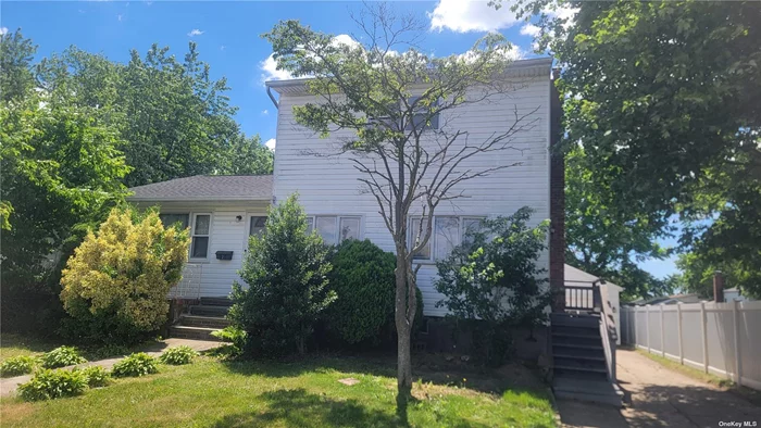 Large Split Level Home In A Great Location. This Home Features 3 Bedrooms 2 Full Baths, Partially Finished Full Basement With An Outside Entrance, Oversized 2 Car Detached Garage. Unlimited Potential, Waiting For Your Personal Touches To Make It Your Own!!