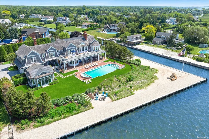 This exquisite bayfront shingle-style residence, meticulously crafted in 2014 by esteemed architect Craig Arm and master builder J.P. Spano, embodies unparalleled quality and elegance. Set on approximately 1.6 pristine acres in the exclusive enclave of Remsenburg, this estate spans 9, 000 square feet of opulent living space. It features 6 luxurious bedrooms, 8 full bathrooms, and 3 refined half bathrooms. Every inch of this custom-built home exudes sophistication, from the 2, 800 square feet of mahogany decking to the state-of-the-art geothermal heating and cooling systems. Additional features include elevator, heated garage floors, a whole-house generator for peace of mind, and a stunning outdoor bar perfect for entertaining. The property boasts a pool house and an attached 3-car garage, seamlessly blending functionality with luxury. The expansive waterfront includes 540 feet of bulkhead, a private wraparound beach, and a double boat slip, providing an idyllic setting for waterside living. With full FEMA compliance, this turn-key oasis offers not only beauty but also the assurance of safety and resilience. This remarkable residence is a testament to timeless elegance and modern convenience, offering a rare opportunity to experience the epitome of waterfront living.