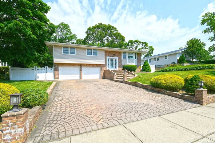 Welcome to this beautifully renovated 4-bedroom Hi-Ranch nestled in the sought-after Bird Section of Hauppauge. Meticulously updated in 2016, this home boasts an inviting open layout that exudes light and brightness throughout. Step inside to discover a tastefully designed interior featuring neutral tones, allowing you the freedom to decorate and personalize each space to suit your unique style. The main level greets you with a spacious living area that seamlessly flows into the dining room and kitchen, ideal for both everyday living and entertaining guests. The kitchen itself is a chef&rsquo;s delight, equipped with modern appliances, sleek countertops, and ample cabinet storage. Enjoy mornings at the breakfast bar or host gatherings in the adjacent dining area with ease. The lower level offers a private Master suite complemented by a cozy fireplace. Outside, the property is enhanced with front and back in-ground sprinkler systems, ensuring lush greenery year-round. Convenient laundry room and large storage space adds practicality and storage solutions.