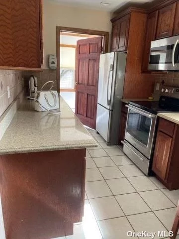 Cosy bright 2 bedroom rental in the heart of Copiague. Updated eat-in-kitchen. Newer full Bath. Spacious living room (with fireplace, ) and dining area with wood floors. Use of lovely yard. Driveway parking.
