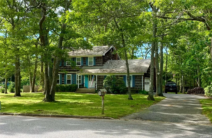 Located in the serene Presidents area of East Quogue, this charming two-story colonial boasts 4 bedrooms and 2.5 bathrooms. Set on a nearly half-acre flat lot, the home features a 2-car attached garage, offering both space and convenience.