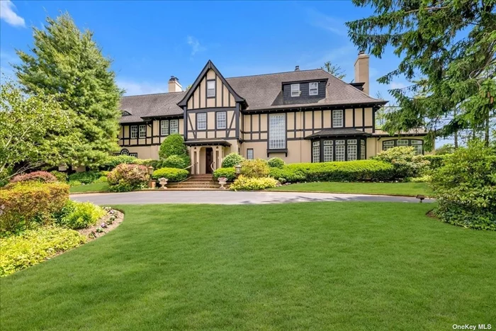 Welcome to This Gracious & Stately 6300 Sq Ft Tudor Style Center Hall Colonial Set High Up on a Sprawling 1.25 Acre Parklike Property With Golf Course Views. Upon Entering the Grand Entry Hall You are Immediately Captivated By The Traditional Elegance. All Spacious Rooms with 9 Ft Ceilings Have a Wonderful Flow Perfect For Entertaining. Living Room with Fpl, Library with Fpl, Den with Doors To Terrace, Large Formal Dining Room with Fpl to Host Gatherings, & Updated Granite/Wood Eat in Kitchen with 2 Sinks, 2 DW, & 2 Ovens Opens into Great Rm.The Second Floor Features 5 Bedroom, 2 Offices & Laundry Rm. Primary Suite Boasts His & Her Baths & Walk in Closet with Custom Cabinetry, 3 Bedrooms with Ensuite Baths, & Magnificent Cabinetry in Home Office. Third Floor Has finished Attic Perfect for Recreation Rm.Unfinished Full Bsmt Provides Opportunity to Create Additional Rooms(Hi Ceiling) Separate Carriage House on The Property Has a Living Rm, Kitchen, 2 Bedrooms & Bth Can Be Wonderful Guest Quarters.2 Car Garage. New CAC, Radiant Ht in Entry Hall, Kit, Powder Rm & Primary Bath. Well Water for IG Sprinklers, .All Top Quality Workmanship Throughout. Must See!!SD#15
