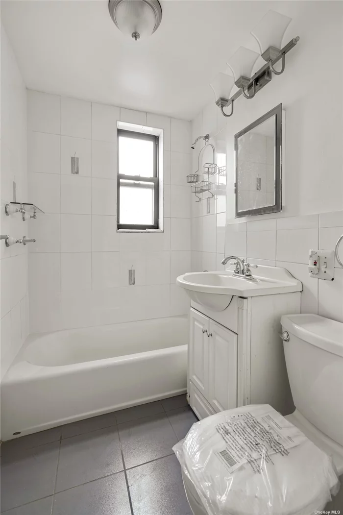 Welcome to this beautifully renovated 2-bedroom, 1-bathroom co-op located at 87-70 173rd St, Queens, NY. This charming home offers approximately 1000 square feet of living space and boasts a total of 4 rooms, including a renovated bathroom and hardwood floors throughout. The galley kitchen is a chef&rsquo;s delight, featuring ample counter space and modern appliances. The open layout of the living area provides a cozy and inviting atmosphere, perfect for entertaining guests or simply unwinding after a long day. For added convenience, this co-op includes a dedicated laundry room, ensuring that household chores are a breeze. While there is a private garage there is currently a waitlist for parking, however, parking can be found on the street. The building offers a video intercom system for enhanced security and peace of mind. Located in a prime Queens neighborhood, this co-op presents an excellent opportunity for comfortable and stylish living. With forced air heating and cooling, you&rsquo;ll stay comfortable year-round.