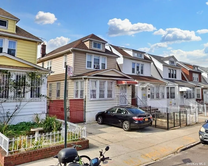 Fully detached four bedroom, two full baths home, with separate garage, nestled on a residential street conveniently located three blocks from the E/F/M/R and 7 subway lines in Jackson Heights. A brightly lit foyer leads to sun room, expansive living room, formal dining room with gorgeous stained glass, and a large eat-in kitchen with swinging door from 1930s. Three spacious bedrooms upstairs, light from all directions, southeast northwest exposures. bathroom with tub, and another staircase leading to dormer attic. Finished basement with another full bathroom. Shed alongside garage; yard space with garden. Two additional parking spaces in driveway. Close to shops, gyms, restaurants, schools, parks, houses of worship, library, post office, weekly greenmarket and CSA, as well as EV charging stations and ZipCar parking. All room photos virtually renovated (items digitally removed); basement photo virtually staged. Next door to a piece of film history. Near Elmhurst Hospital. Appliances not included: washing machine; commode cover; refrigerator. Sold as is.