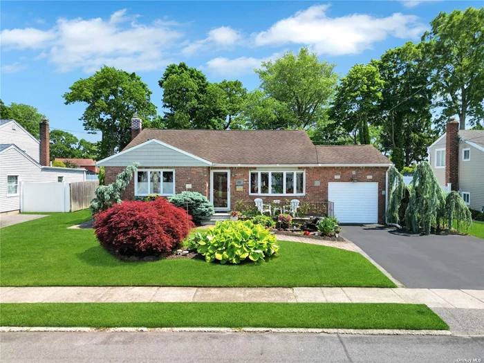 Welcome to this well maintained 4 Bedroom, 2 Bath Split Level located on a beautiful, oversized lot in North Babylon. This home is Elegant inside and out. Pull up to a front yard oasis with beautiful landscaping and an easy to maintain koi pond. As you enter into the formal dining room you will see beautiful, vaulted ceilings and custom Mahogany trim oak wood floors. The large eat in Kitchen is filled with plenty of cabinets and counter space. As you enter the Living Room with vaulted ceilings and a gorgeous marble tiled gas fireplace. Floor level laundry room with easy access. Upstairs has three bedrooms with hardwood floors throughout including a marble tiled bathroom with Heated floors even in the shower!! The semi above ground lower level includes a separate outside entrance, extra bedroom and full bathroom that can be for family or potential rental income with proper permits. This huge backyard great for entertaining is a must see with plenty of privacy, patio with awning and sprinklers with the potential to do whatever you please!! A/c is a little over ten years old. Heating system was replaced December 2021. Roof is in great condition with updated chimney, flue and cover. Full dry crawl space with tons of storage. 200-amp electrical panel with added generator plug. Tons of Storage Space!