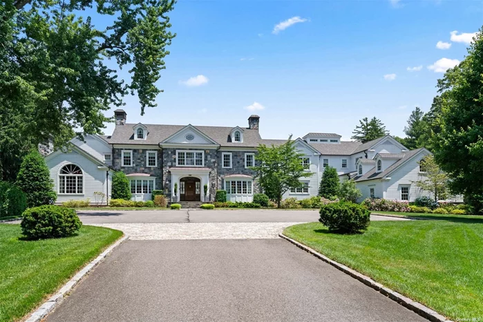 Collaborating with the homeowners, noted architects, Innocenti & Webel created a thoughtful residence with a well curated design. Custom built only seven years ago, this smart home transcends the competition with its organic textures, luxurious finishes, craftsmanship and quality construction. A long winding drive leads to the gated entry and 8.06 lush acres with specimen trees and flowering hydrangea, lilies, and roses. The pool house with full Bath, Kitchenette and Living Room overlooks the gunite pool with stone wall featuring refreshing water spouts. Interiors are graced with the subtle patterning of herringbone wood floors, high ceilings with unique coiffering and beams, and custom wall treatments. Graceful, well proportioned principle rooms are filled with light from French doors that run along the rear corridor of the home. The Kitchen boasts a breakfast nook with wood paneled ceiling, top of the line appliances, 3-inch marble counters, a hammered metal farm sink and 2 Butlers Pantries. The first has a brass countertop, second dishwasher and decorative shelving, while the latter offers thick butcher block counters for food prep. The spacious Family Room and beamed cathedral ceiling offers a large stone fireplace for cozy gatherings. Other highlights include a stately office with fireplace, Billard Room with wet bar, main floor nanny suite plus elevator. The Primary Suite is a calming retreat with huge walk in closets and two spa-like Bathrooms. There are 4 additional En Suite Bedrooms with outfitted closets. The lower Level, accessed by 2 staircases on each end of the home, has a large Home Gym, Sport Court, Game Room, En Suite Bedroom and A Seating Area. Additionally, a 10-Seat home Theatre and Wine Cellar make for spectacular entertaining on this level. Approved plans for a tennis court.