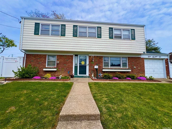 This spacious, light-filled split-level home features three bedrooms, 1 1/2 baths, and a stunning cathedral ceiling in both the living and dining rooms. With a cozy den, a dedicated home office, and ample closet space, this home offers plenty of room for comfortable living. Hardwood floors flow throughout, enhancing the warm and inviting atmosphere. Set on a generous fenced 75x100 property, the home boasts a new roof, providing peace of mind for years to come. Its prime location ensures easy access to shopping, schools, and the Long Island Railroad, making it an ideal choice for convenience and connectivity.