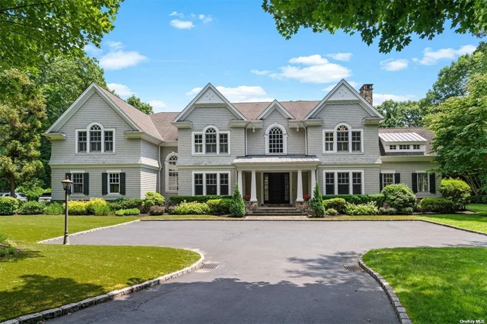 Nestled on a serene private road, this elegant cedar shake Colonial in Laurel Hollow/Oyster Bay Cove offers a tranquil retreat. Spread across 2.33 acres of meticulously landscaped grounds, this pristine -6700 sqft home exudes sophistication and charm. Step into a two-story foyer adorned with herringbone white oak floors, detailed ceiling moldings, and graceful interior archways, all beneath lofty ceilings that enhance the sense of space and light. The heart of the home is a recently renovated, top-of-the-line eat-in kitchen featuring a Viking oven, gas cooking, marble island and backsplash, a butler&rsquo;s pantry, and a sunlit breakfast area surrounded by windows. Dining room, living room with fireplace, office with French doors to bluestone covered terrace, water closet, laundry room, guest bedroom and full bathroom with pool access complete the first level. Ascend either of the two staircases to discover the second level, home to four en-suite bedrooms, each outfitted with walk-in closets. The crown jewel is the -1000 sqft primary suite, featuring a sitting room with a fireplace, two walk-in closets, and a rooftop deck overlooking the lush yard. The luxurious marble bathroom, with its soaking tub and steam shower, offers a spa-like retreat. An additional 15&rsquo;x28&rsquo; room provides versatile space for a gym, sixth bedroom, or recreation room. The home also includes a three-car garage and a full basement with 10-foot ceilings, offering abundant storage. Resort-like property with irrigation system, specimen plantings, bluestone patio, saltwater gunite pool/spa with electric cover, pergola with fireplace and outdoor kitchen, perfect for everyday living or entertaining. Laurel Hollow Village Beach (fee) with kayak storage and mooring rights just down the road. Only 4 miles to Syosset Train Station with direct line to Penn and Grand Central Stations. Enjoy the nearby quaint villages of Oyster Bay and Cold Spring Harbor with restaurants, shopping, parks and more. Choice of Cold Spring Harbor or Oyster Bay School District. Total Taxes: $52, 823/yr