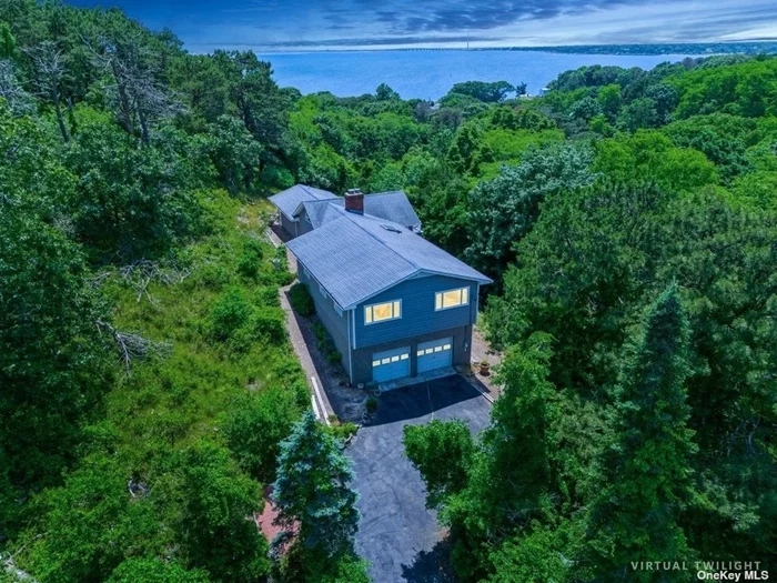 Located in Southampton, south of the highway, stands an opportunity to take possession of prime, glorious bay & ocean views at attractive pricing.  Uniquely elevated with unobstructed views, surrounded by 15+ acres of protected land owned by the Peconic Land Trust creates a peaceful, private dwelling to forever enjoy.  Room to renovate and expand.  Room for pool with a variance.  No clearing restrictions according to Southampton Town.  3 bedrooms, 2 baths, office and legal lower level.  Updates recently made.  Call today for access.