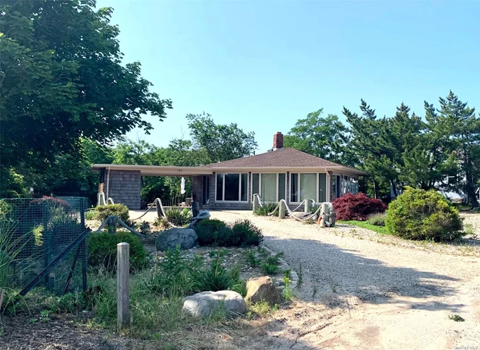 Quintessential mid-century modern beach house with million dollar views across from one of the most desirable Long Island Sound beaches on the North Fork. This unique hexagonal home has an open floor plan with spectacular views, cathedral ceiling, and curved wood burning fireplace. Three bedrooms are tucked around the back, including a primary bedroom with ensuite bathroom. A carport extends to a fully enclosed seasonal shower and sink. Owners will provide bicycles, paddle board, and outdoor gas grill.