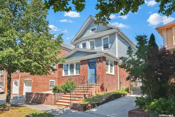 This legal detached part-brick 3-family house underwent a complete gut renovation in 2023/2024. It sits on a lot measuring 29.58X100 with a building size of 19X52. The first floor features a spacious layout including a sun room,  living room, formal dining room, 3 bedrooms, an eat-in kitchen, and a full bathroom with heated floors. On the second floor, there are two one-bedroom apartments. The renovation included the installation of 3 new kitchens with tiled floors, granite countertops, and stainless steel appliances, along with 3 brand new modern bathrooms. Updates encompassed new walls, windows, chimney, siding, and fencing. Plumbing was entirely replaced, and electrical systems were partially updated, with 3 electric meters and 2 gas meters now in place. Additional amenities include a private driveway and a large one-car garage. The property presents like a newly constructed home and will be delivered vacant. It is conveniently located near E, F, R, J & LIRR train lines, as well as schools, houses of worship, and shopping centers.