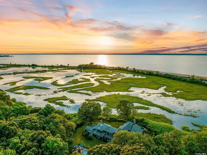 An incredible 2 acre property overlooking the Long Island Sound, wetlands, tidal creek and abuts Oyster Bay National Wildlife Refuge with magnificent sunset views. Watch the tides come and go along with breathtaking wildlife. Custom built in the 80&rsquo;s, redesigned and rebuilt in 2002. Two story spacious Entry Hall sets the tone for this very special home which has 18 bright rooms. Many have access to the wonderful porches. Two Primary Bedrooms with ensuite baths, one on the first floor. A home built for entertainment and gracious living. The heated gunite pool has slate and herringbone design. It is perfect for all types of life styles. A home for everyone!