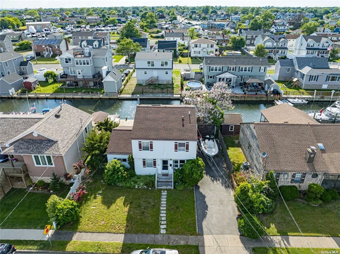 Lindenhurst Two Family Waterfront Home on a Deep Water Canal Leading to the Great South Bay! The first floor features a charming one-bedroom layout with a spacious living room, dining room, updated full bathroom, and an eat-in kitchen that opens to a patio through sliding glass doors. Upstairs, you&rsquo;ll find a two-bedroom unit with a full bathroom, living room, and another eat-in kitchen. Sliding glass doors lead from the kitchen to a deck offering magnificent views. This property is a must-see for anyone seeking a waterfront lifestyle with dual living potential. Come take a look!