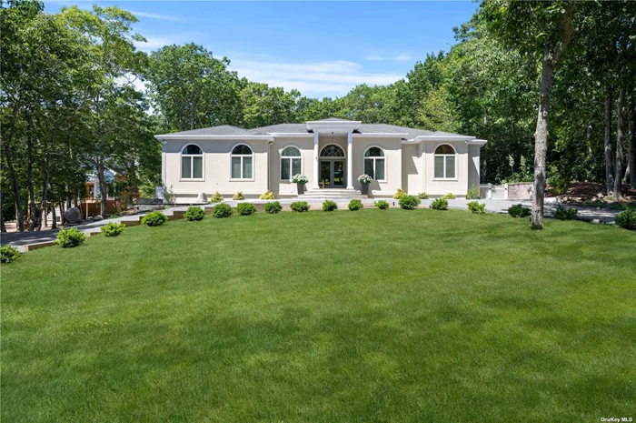 Experience coastal living at its finest in this bright, East Hampton single-story retreat. Perched on an elevated lot and nestled away from the road, this 2, 650+/- sq. ft. light filled residence on 0.59+/- acres boasts vaulted ceilings and expansive windows. It features three bedrooms, three baths, and an open-concept layout with a living room, dining area, gourmet kitchen with granite countertops and a breakfast nook, family room with a wood-burning fireplace, a study or potential fourth bedroom, and a laundry room. The luxurious primary suite features high ceilings, a spa-like en-suite bathroom with heated floor and dual walk-in closets. The home effortlessly extends to the outdoors via multiple sliders, blending indoor and outdoor spaces seamlessly. Outdoor amenities include an 18x36 pool and a sprawling stone patio. Additional features include an underground, two-car heated garage with interior access staircase, a 2, 200+/- sq. ft. unfinished basement, central air, central vacuum, multi-zone HVAC, and more. Situated within the esteemed Hampton Waters Association, residents enjoy access to pathways leading to Three Mile Harbor, boat docking for day use, mooring rights, paddleboard and kayak storage areas, and a communal green space leading to the association beach.