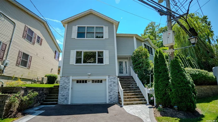 Welcome to 67 Avenue C! A stunning 3-bedroom, 3.5-bathroom Colonial located in the heart of Port Washington. This beautifully renovated/decorated home offers the perfect blend of modern convenience and timeless elegance. Nestled in a private setting, this meticulously maintained property boasts a host of premium features. To name a few, a Advanced Lutron Connect Lighting System: Enjoy wireless control of all lighting, ensuring your home is always perfectly illuminated from wherever you may be and for any occasion, Fully Sprinklered, Beautifully landscaped, allowing for easy maintenance, a 2022 Fully Renovated Basement: Featuring a luxurious full bathroom with hand-laid pebble stone in the shower, a wet bar for entertaining, and a separate heating and cooling zone for optimal comfort. Enjoy a total of Three Zones of Heating and Cooling throughout the home: with Wireless control capabilities providing unparalleled convenience and efficiency. Your Elegant Formal Dining Room: Perfect for hosting dinners and gatherings with an additional wet-bar just steps away, A Renovated Kitchen (2022) with a large center island: Equipped with a 2023 appliance package and finishes, ideal for the culinary enthusiasts. Once you are ready to unwind, you can head upstairs to the Primary Suite: A luxurious retreat with a shower and jetted tub, offering a spa-like experience at home. Lets not forget to mention the Brand New 2023 Asphalt driveway with paver boarder, Hardwood Floors throughout the home for timeless elegance and 2022 Renovated pack patio and so much more!