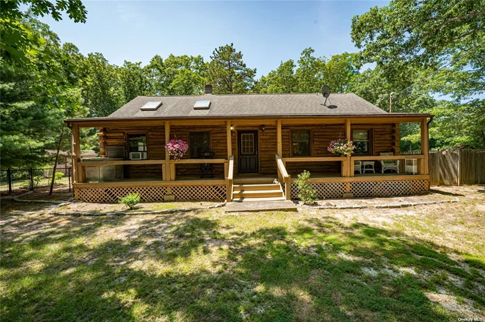 Long Island log cabin living! You feel like you&rsquo;re upstate in the mountains when you walk into this unique home. Open concept living room, dining room and kitchen with high vaulted ceilings and 4 skylights, Right in the center is a huge wood burning stove that you can actually cook on. Wide plank wood floors through-out. Walk out onto the deck through a beautiful Anderson sliding door to stock up on firewood. Primary bedroom with 3 windows and 2 closets, second bedroom, and a large full bath fill out the rest of the main level. The second level is a fully finished attic that can be used as a 3 bedroom. But wait, there&rsquo;s more! There is a sprawling, fully finished basement with large living room, bedroom, dressing room or office, huge bathroom with walk-in shower and the washer and dryer. With proper permits and added access, this could be an accessory apartment or space for a parent or older child. The exterior has great outdoor living space with a covered front porch perfect for a row of rocking chairs, the front yard is completely fenced in, perfect for kids or pets to run around and play safely, decking in the backyard, and a long driveway that goes from one side of house to other. You can actually pull right up to the the kitchen door to unload groceries. The back yard is so spacious, it is just asking you to put in a built-in pool or separate garage. There are so many possibilities! Come and see - this could be your home!