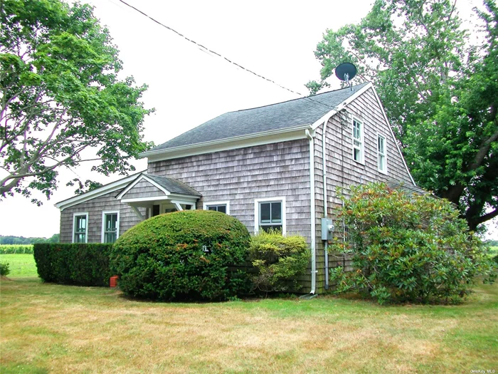 Enjoy the quiet country life when you move into this tastefully-furnished honest and adorable history home nearly hidden by mature shrubs and trees on a quiet country lane. Delight in awe-inspiring sunsets and skyscapes and savor fresh produce harvested from your own garden plot. Then wash your cares away in the rustic outdoor shower! Set on two pastoral Cutchogue acres and surrounded by lands of Macari Vineyards and world-renowned greens purveyor Satur Farms, you will be immersed in the North Fork&rsquo;s nearly four hundred year agricultural tradition.  Is this the perfect spot for a yearround second home? Nothing compares! Come visit soon!