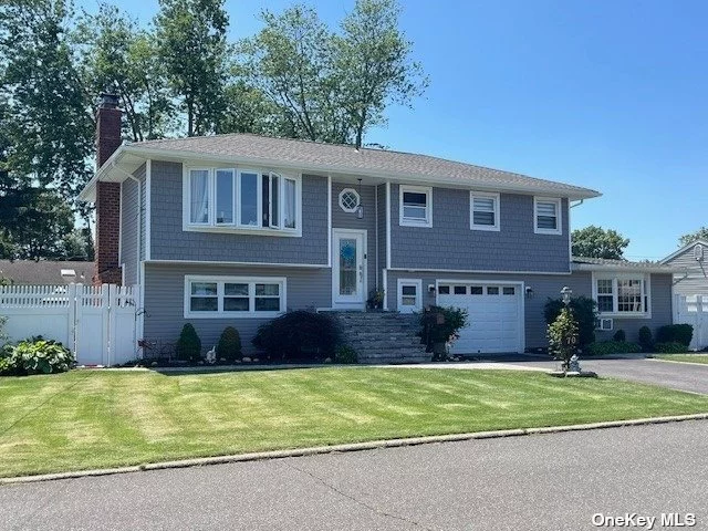 This Hi Ranch boasts great curb appeal with its new vinyl siding and stone facade, complemented by a fabulous four-room extension on the first floor that includes a kitchen, living room, dining room, bedroom, full bath and private entry. It&rsquo;s connected to an oversized one-car garage leading to a three-bedroom, two-bath Hi Ranch with rare partial basement for storage with Bilco door entrance. This home offers ample space for everyone. The property features a fully fenced yard, an in-ground pool, patio, manicured lawn, and a multi-car driveway, conveniently located near schools, shopping, restaurants, LIRR, parks, parkways and more...