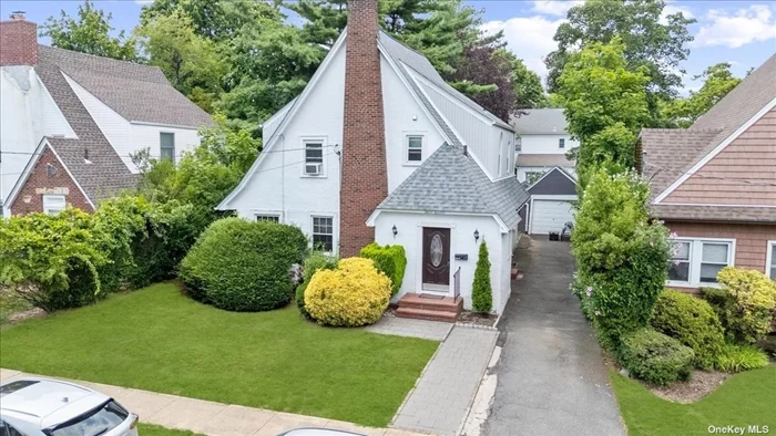 Welcome to this beautifully renovated traditional home nestled in the highly sought-after Hewlett/Woodmere School District. This 3-bedroom, 2.5-bathroom Center Hall Colonial boasts sophisticated neutral tones, pristine wood flooring, and white walls. The updated kitchen is a chef&rsquo;s dream, featuring sleek white quartz countertops, stainless steel gas appliances, large 8 x 8 ceramic tiles, and stylish black square bar pulls. The 2-toned cabinets add an elegant accent, complemented by a matching white quartz backsplash. Relax in the spacious living room, which showcases a beautifully appointed, white-boxed fireplace with a natural pine mantel. Enjoy hosting dinners in the elegant dining room, perfect for entertaining guests. The oversized primary bedroom suite is a luxurious retreat, offering a private full bathroom and ample closet space. Two additional bedrooms share a full bathroom, ideal for family or guests. The backyard is an oasis, complete with custom patio pavers and charming flower beds, adding those perfect homey finishing touches. Situated on a picturesque tree-lined street, this home provides the convenience of being close to everything - including the LIRR, Grant Park, and local shopping and places of worship. Additional highlights include a detached 1-car garage, low taxes, and no flood insurance requirement. Experience the wonderful flow and timeless charm of this home firsthand.