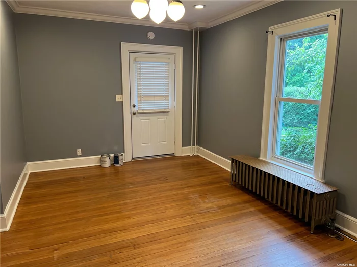 Move right into this 1 bedroom apartment in the heart of the village of Sea Cliff. Features an eat-in-kitchen, as well as a large living room. This unit is freshly painted and boasts hardwood floors throughout. Enjoy the deck and sweet porch going into the private entrance. Easy to get around with nearby shops, restaurants, railroad, bus and beach. Includes heat and water. Driveway parking.