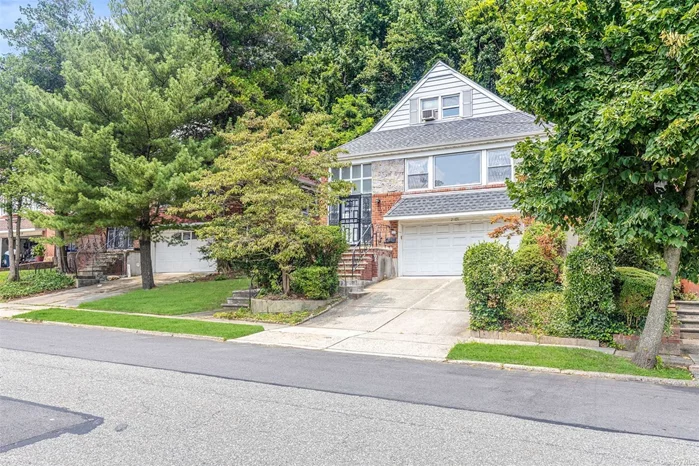 Welcome to the Parkside Hills section of Queens featuring the perfect blend of residential living with low taxes! This spacious split-level home features a foyer with a choice of going upstairs or downstairs. Following the beautiful hardwood floors throughout the house you&rsquo;ll be captivated by the huge living room and dining room, complete with stunning bay windows that flood the space with natural light. The updated kitchen is a true delight featuring brand new appliances. Continuing upstairs, you&rsquo;ll discover 4 generously sized bedrooms and 2 fully updated bathrooms, providing ample space for the whole family. The basement is a true gem, offering tall ceilings and a separate entrance along with a dedicated laundry room, plus a convenient two-car garage. The property can even be configured as a mother-daughter setup with the proper permits. This spacious home offers easy access to all forms of transportation as it&rsquo;s located north of Hillside ave near Springfield Blvd and Grand Central Parkway. Rarely do homes in this area come on the market. Don&rsquo;t miss this one!