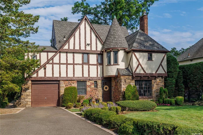 WOW! This Immaculate Tudor w/ its Large room sizes & updates throughout is a must see! Set beautifully on an impressive tree lined street this home has it all. Incredible details such as gorgeous hardwood floors, Mouldings, Radiant heated floors, 2.5 brand New Baths, a large Family room, Home office, plus a Bonus space on 3rd floor! Spacious LR w/ Fireplace plus large eat in kitchen , off the formal Dining room, is perfect for entertaining ! Mudroom area , Laundry on 2nd Floor plus the attached garage! Private yard plus walk to Wilson School all add to the charm of this special home!