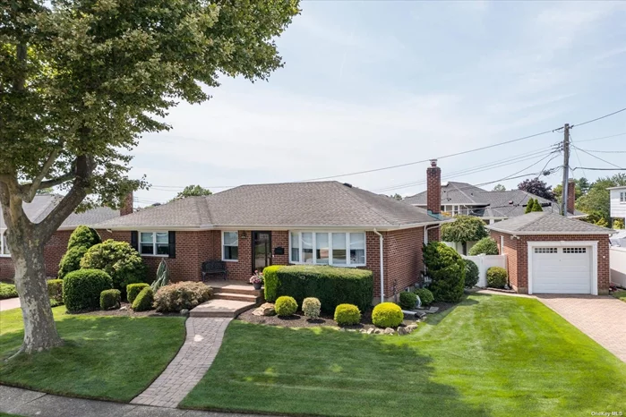 Meticulously maintained, this stately brick ranch, in the Hahn Estates section of Bethpage, boasts an open floor plan living & dining room, eat-in kitchen w/ SS appliances, glass tile backsplash and Corian counters, as well as a beautiful, full, finished basement! Recent updates include refinished hardwood floors, doors and moldings, multiple windows, roof, gutters and more! Sitting on an impressive and beautifully-manicured property w/ PVC fencing, awning, slate patio, in-ground sprinklers, paver driveway and detached garage, this home is made for entertaining and boasts major curb appeal! NATURAL GAS, SEWERS AND CENTRAL AIR!