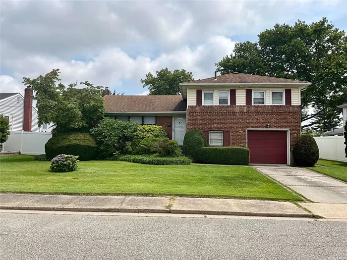 Move right into this lovingly maintained brick split level home and make it your own as you go. With attached garage, Hardwood floors throughout, CAC 2-3 yrs old, Gas heat and cooking, stand alone water heater, and total 200 amp. electric. Primary bedroom has newer ensuite. Main bath is also nicely updated with full tub. Ground level family room has attached Mud room perfect for snow boots and umbrellas! The laundry room has an additional 1/2 bath! Reasonable taxes, Hicksville SD