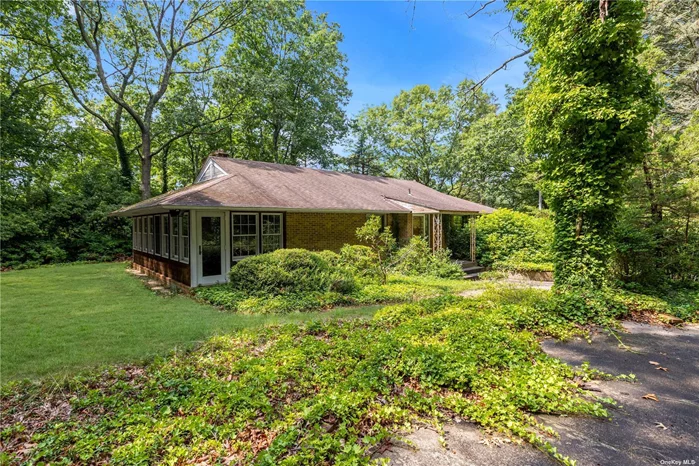 Discover your sanctuary in this charming Cedar and Brick Sided Ranch nestled in the tranquil village of Laurel Hollow, part of the prestigious Cold Spring Harbor School District. This 3-bedroom, 2-bathroom haven sits on a lush 2-acre lot, offering the perfect blend of privacy and convenience-just minutes from the Cold Spring Harbor Train Station and Northern State Parkway. As you enter via the circular driveway, you&rsquo;re greeted by a welcoming facade that hints at the potential within. The spacious living room features a cozy fireplace and large picture windows that frame serene views of the wooded property, creating a peaceful atmosphere for relaxation. The sunroom, bathed in natural light, offers versatile use as a den or home office-ideal for today&rsquo;s remote lifestyle. With a full finished basement and an open staircase leading to it, this home is bursting with possibilities. The attached 2-car garage adds convenience, while the surrounding luxury homes enhance the neighborhood&rsquo;s appeal. Whether you envision a custom renovation or a grand expansion, this property is a canvas awaiting your touch. Don&rsquo;t miss the chance to turn this hidden gem into your dream home!