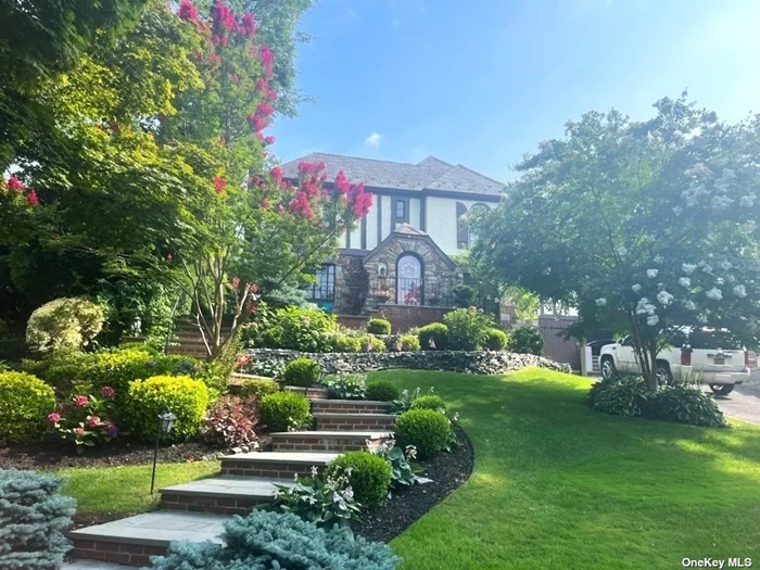 This is a storybook Tudor renovated in 2017. The first floor features a large living room with stone fireplace, formal dining room, powder room and updated kitchen with eating area. The second floor offers a primary suite with full bath and adjoining enclosed sun porch, 2 additional bedrooms and full bath. The lower level has laundry, playroom and represented full bath. The house has a nice private yard. It is landscaped beautifully and has a charming patio area in the front of the house.