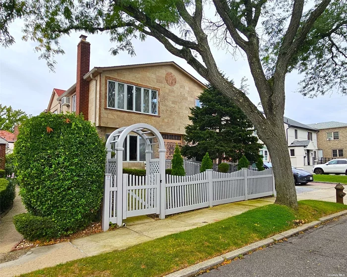 Nestled in the heart of Hollis Hills, this stunning brick and stucco colonial is a rare find. With modern upgrades and an oversized floor plan, it is ideal for a growing family. Recent renovations in 2022 provide a fresh start for creating your dream home. The first floor welcomes you with a cozy living room featuring a wood-burning fireplace. A formal dining room, eat-in kitchen with an island, den, bedroom, and full bath complete this level. Upstairs, the primary bedroom suite includes a sitting area and en suite full bath, accompanied by three additional bedrooms and another full bath. The finished basement offers versatile space with a family room or office, full bath, laundry area, storage, and a separate entrance. Additional features include an attached one-car garage, new driveway, new roof, inground sprinklers, 4-zone gas heat, central air conditioning plus a split unit, and zoning for School District 26. This exceptional home is ready for your personal touch to make it the perfect family haven.