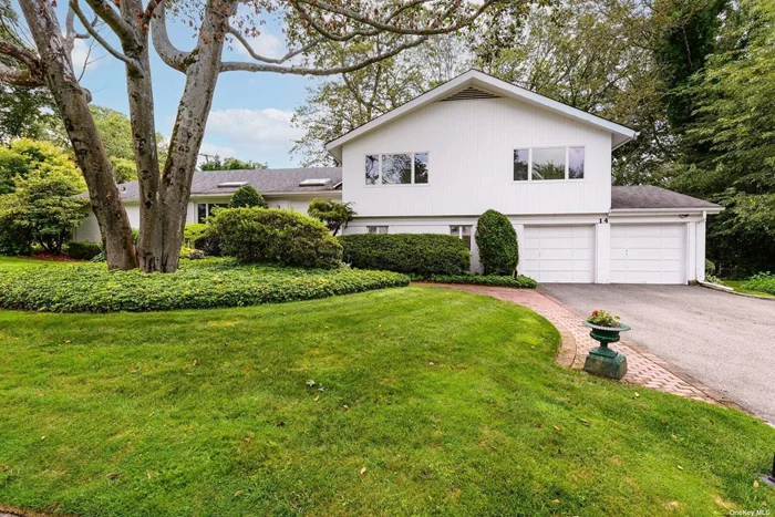 Nestled in an oversized corner lot in Nob Hill/Lakeville Estates, this sprawling split-level has 11 foot ceilings on the main level, tons of sun and was built for entertaining. The large, inviting, front to back living room is splashed with natural light. The dining room, off the living room , continues a bank of glass sliders to the deck. This flows into a spacious den with cathedral ceiling, wood beams, sliders out to back and circles round to the kitchen. A spacious eat-in-kitchen with skylights is the center of the home. Upper Level Primary Bedroom has a wall of closets and a full bath with a large tub/shower. The two other bedrooms share a hall bath.The lower level is perfect for multi-generational living. It was fully renovated for handicap access with a bedroom, full accessible bathroom and den with sliding glass doors to a patio which completes the space. There is also a basement for utilities and storage. Full house generator. Gas Heat. Membership in East Hills Park. Roslyn Schools.