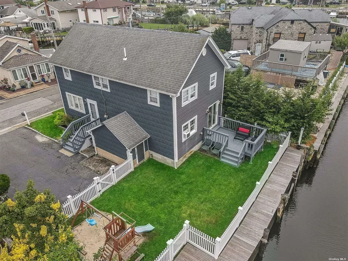 This stunning canal front home is located in a prime Bellmore neighborhood. This colonial home boasts 4 bedrooms with 2 full baths. The first floor features a large living room, eat in kitchen, laundry area and a full bath. The second floor features a primary suite with 3 additional bedrooms and a full bath. The backyard is a true oasis. The deck overlooking the canal allows for entertaining guests or simply relaxing and enjoying the views. Updated bulk head allows you to pull up your boat after a short ride to the bay. The home was completely renovated in 2018 with a chefs kitchen with stainless steel appliance to the updated bathrooms. The electrical panel was updated as well. Home has gas utilities, new vinyl siding and gutters. The home was elevated 3ft with steel beams. The home has a vapor barrier system. This Bellmore canal-front home is truly one of a kind property. It is the perfect place to call home for anyone who loves to enjoy the water front lifestyle.