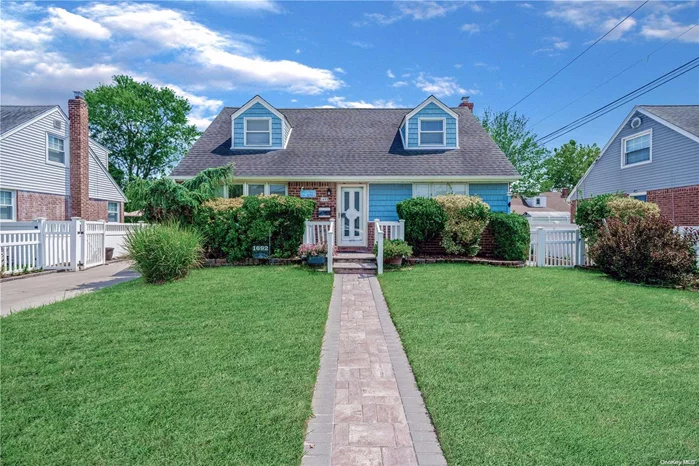 Beautiful 4-bedroom, 2.5-bath expanded Cape located in the desirable East Meadow neighborhood with a charming front porch. The first floor features an inviting living room, dining room,  two spacious bedrooms, a full bath, a large kitchen with granite countertops, stainless steel appliances, and a door leading out to backyard. The second floor includes two large bedrooms and a full bath. The full finished basement offers additional family space, a half bath, and a laundry area. This house is equipped with central air conditioning, natural gas heating and cooking, a generator hookup, a remote-controlled awning, and a 2-car garage with a long driveway. The private fenced backyard boasts a lovely garden area, a huge deck with a retractable electric awning, a shed, and a walkway along the side of the house. Close to schools, Eisenhower State Park, shops, and transportation. East Meadow school district! Low taxes!