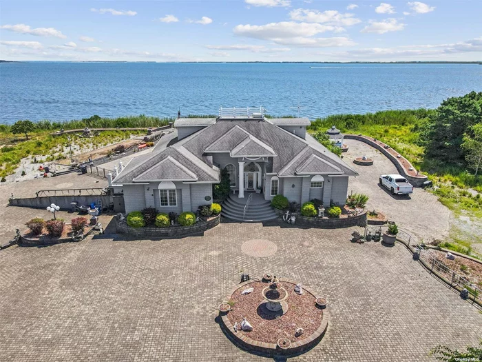 *****Experience the ultimate in serene waterfront living****with this nearly 8-acre custom-built residence on the Great South Bay. This unique 5-bedroom, 2.5-bathroom home offers a perfect blend of luxury and comfort, featuring nearly 3, 600 square feet of beautifully designed living space. Enjoy the convenience and privacy of a main-level master suite. Custom-built kitchen and formal dining room perfect for everyday meals and grand gatherings. Cozy up in the inviting family room with a fireplace, or unwind in the additional living room also featuring a fireplace. Versatile loft area or family room with a stunning spiral staircase leading to the crow&rsquo;s nest, where you can enjoy panoramic views. Plenty of room for guests or staff accommodations. Comfort year-round with central air and ample storage space. Outdoor living made easy - Relax and entertain in your private in-ground pool. and Outdoor Shower, Conveniently located for a refreshing rinse after a swim. Custom Moldings Throughout, Exquisite craftsmanship and attention to detail. This one-of-a-kind property is not just a home; it&rsquo;s a lifestyle. Don&rsquo;t miss your chance to own a piece of paradise on the Great South Bay