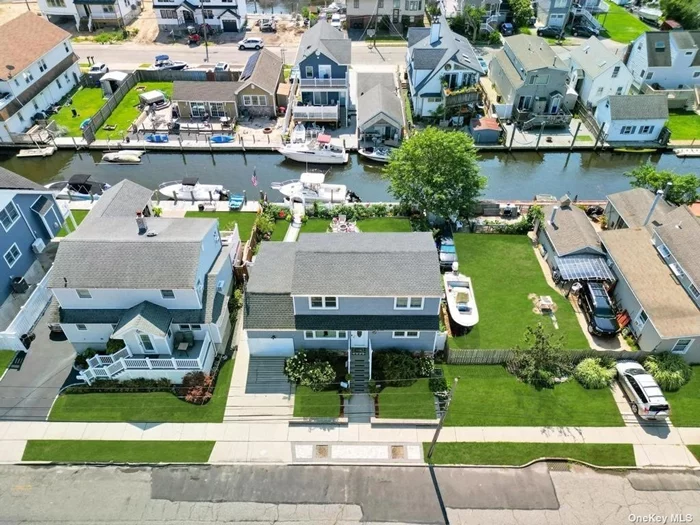 Welcome to your dream waterfront retreat in the coveted Lindenhurst Village! This expanded Cape offers four bedrooms, two baths, and every luxury detail for a serene lifestyle. The open floor plan is perfect for entertaining, with a top-of-the-line eat-in kitchen featuring luxury finishes. The main level includes two bedrooms, a full bath, a laundry room, and a spacious garage with ample storage. Upstairs, find a generous third bedroom, another full bath, and a primary bedroom with a walk-in closet and breathtaking water views. The home boasts modern updates, including new central air, a Navien energy system, a new roof, siding, hardwood floors, and Anderson windows. The outdoor space is ideal for al fresco dining on the new deck and patio, where you can unwind in the tranquil waterfront setting. Enjoy village amenities like Venetian Shores, vibrant downtown Lindenhurst, and easy access to the LIRR, public transportation, and a quick train ride to Manhattan. Plus, you&rsquo;re just 20 minutes by boat to Fire Island.