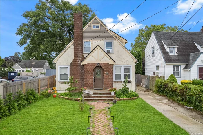 lovely and charming Tudor Cape with lots of potential hardwoods flrs, high ceilings full finish basement.