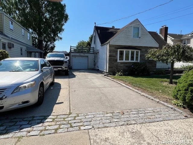 This is a beautiful updated First floor of the house with Private entrance to new eat in kitchen , large living room, 2 spacious bedrooms, wit full finished basement with a full Bath. all hardwood floors. Laundry and family room in the lower level.