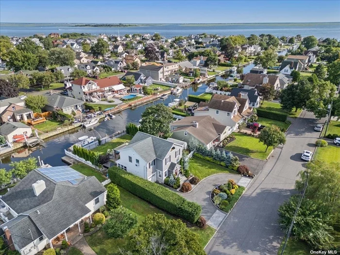 Fabulous waterfront colonial with boating access and loads of renovations! Located just moments from the Amityville Cut, this waterfront Colonial is a dream for boating enthusiasts, offering 60 feet of navy bulkheading and composite decking along with a floating dock. The outdoor oasis is beautifully designed with a gas fire pit, elegant pavers, and a gazebo, all surrounded by professional landscaping with in-ground sprinklers. The yard is set up for the ultimate in relaxation. The home has been thoughtfully renovated, including a new roof, siding, windows, and a 2nd floor addition in 2013. The open-concept kitchen is a chef&rsquo;s delight, featuring a professional-grade stainless steel range, granite countertops, and ample cabinet space. The interior features hardwood floors throughout, enhancing the warmth and style of the home. The flexible living space includes a first-floor bedroom, perfect for guests and another space that could be a home office. Upstairs, the primary suite offers a private balcony overlooking the beautifully landscaped yard and canal. Additional conveniences include walk-in closets, and a second-floor laundry. This home offers the perfect blend of comfort and convenience, ideal for those who love waterfront living all with fantastic curb appeal.