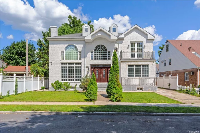 Welcome to this luxurious 3, 588 square feet home in Bellerose Mano. Built in 2006, this full-brick home boasts a timeless exterior with a detached garage, a large backyard, a balcony, a sunroom, and a patio, all contributing to its charming appeal. Wood flooring throughout the interior adds warmth and elegance. Step inside to a spacious first floor, where cathedral ceilings create an airy ambiance in the living room. The open-concept dining area flows into a large, well-appointed kitchen, making it perfect for both everyday living and entertaining. This level also features two generously sized bedrooms and a full bath. The seamless indoor-outdoor transition leads to a backyard patio, ideal for outdoor gatherings. Ascend to the second floor, where you&rsquo;ll find three en-suite bedrooms, each offering its own private full bath. The master suite is a true retreat, complete with a private balcony and a sunroom. The fully finished basement extends the living space, offering a cozy den/family room, two additional versatile rooms, ample storage, an electrical room, and a convenient laundry room.