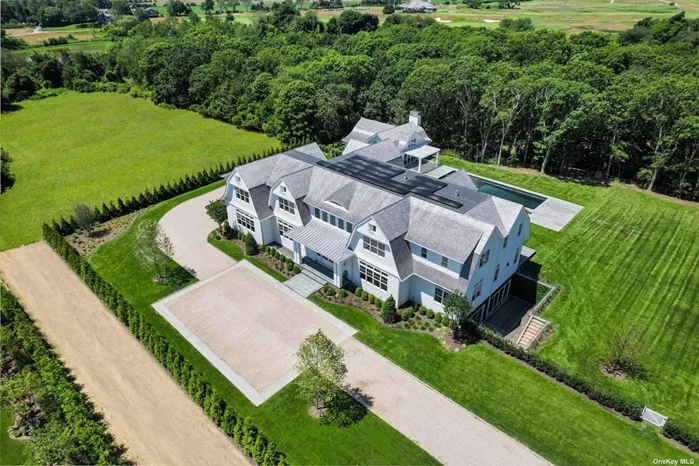 Discover the pinnacle of Hamptons luxury living, ready for an extraordinary Summer 2024, ideally situated at the junction of Water Mill and Bridgehampton. Completed in 2023, this newly crafted marvel is a showcase of architectural brilliance and lavish living, nestled on over 2.5 acres of immaculate grounds. This vast estate, encompassing 14, 750 sq. ft., features 8 opulent bedrooms, 10 full and 1 half baths, along with a host of extravagant amenities, including a sunken tennis court, cutting-edge movie theater, enhanced spa, a fully outfitted home gym, a heated gunite pool, and a refined pool pavilion. Located near the esteemed Two Trees Farm and Atlantic Golf Club, this residence offers the ideal blend of peaceful seclusion and prestigious social venues. The interiors radiate a bright and airy atmosphere, thanks to the dramatic floor-to-ceiling windows that merge the breathtaking outdoor views with the sophisticated design of the open floor plan. The estate is a sensory experience, featuring a remarkable movie theater with a superior sound system, and an enhanced spa area designed for ultimate relaxation. The culinary experience is elevated with a gourmet eat-in kitchen showcasing top-of-the-line appliances, a sun-drenched breakfast nook, and seamless access to the outdoor patio for al fresco dining. Entertain with flair in a formal dining room that includes a built-in wet bar and fireplace, creating the perfect setting for memorable evenings. Beyond the formal elegance, the estate offers numerous spaces for relaxation, work, and entertainment, including a formal living room with a gas fireplace, a library, and a den/office. The luxurious primary suite impresses with a double-sided fireplace, a private sitting lounge, and ensuite bedrooms filled with natural light, with several offering private patio access. Outdoor living is reimagined with a stunning pool pavilion and a 2.5-acre landscape featuring a sunken tennis court and a spacious bluestone patio with three gas fire pits, offering an ideal setting for evenings under the stars. The chic pool house, with its expansive windows, tall ceilings, and open seating area, is designed for sophisticated entertaining. The entire estate is outfitted with an advanced lighting and control system, ensuring comfort and convenience are always at your fingertips. This property is more than a home; it&rsquo;s a lifestyle statement, embodying magnificence and tranquility. Situated between Bridgehampton, Water Mill, and Sag Harbor Village, it places the best of the Hamptons-from world-famous beaches and marinas to boutique shopping, equestrian events, and golf-right at your doorstep. Embark on a journey of luxury living in one of the Hamptons&rsquo; most desirable locations.